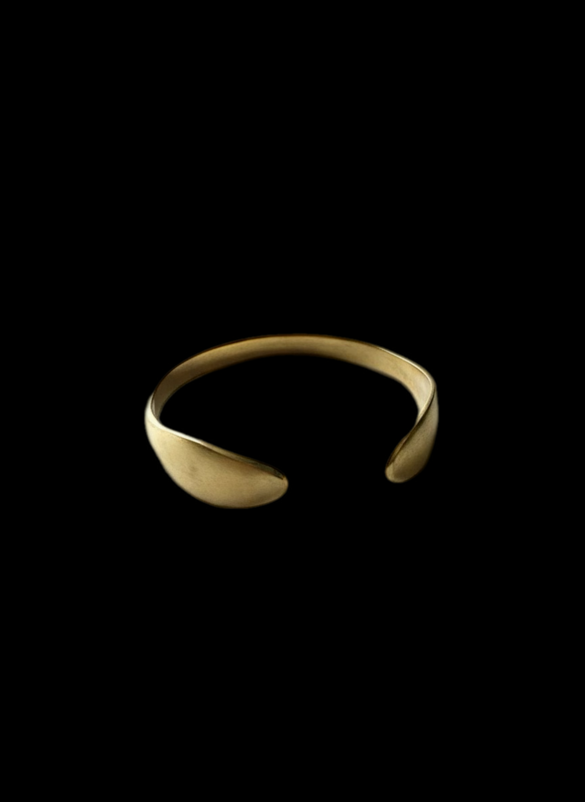 Open cuff crafted from yellow brass with a geometric design, featuring a wide band and adjustable fit.