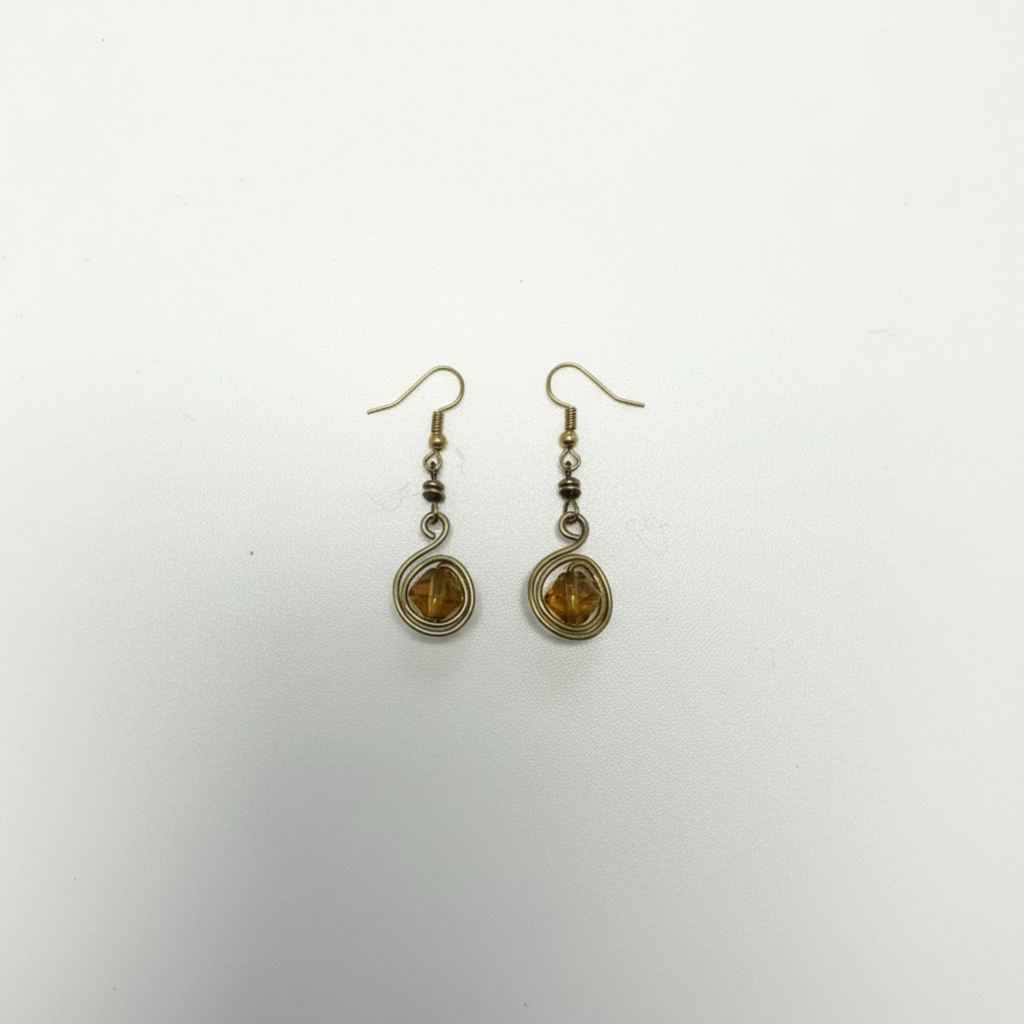 Drop earrings featuring wire-wrapped round glass stones and geometric detailing in yellow brass.