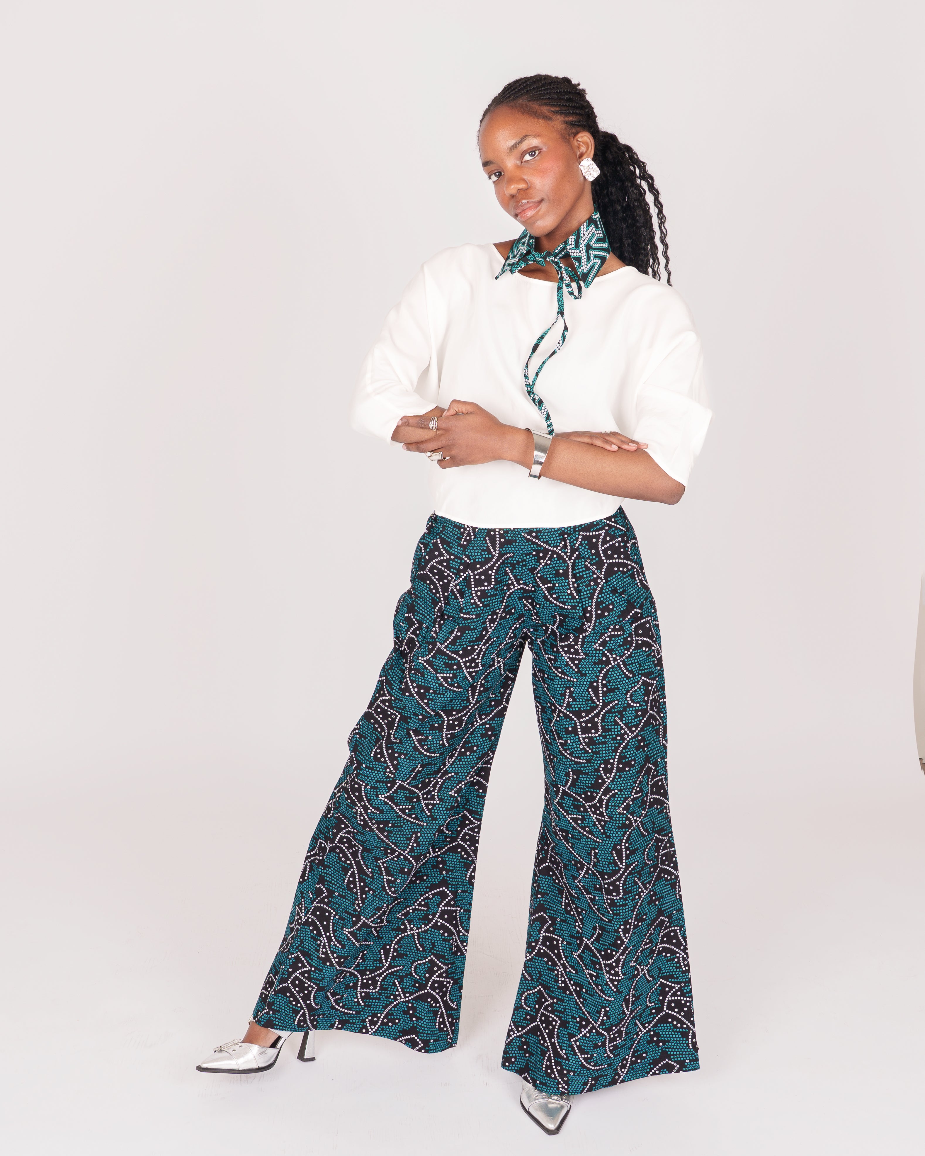 Wide leg pants featuring a fitted waist, hidden zip fly, and seam detailing for an effortlessly elegant look.