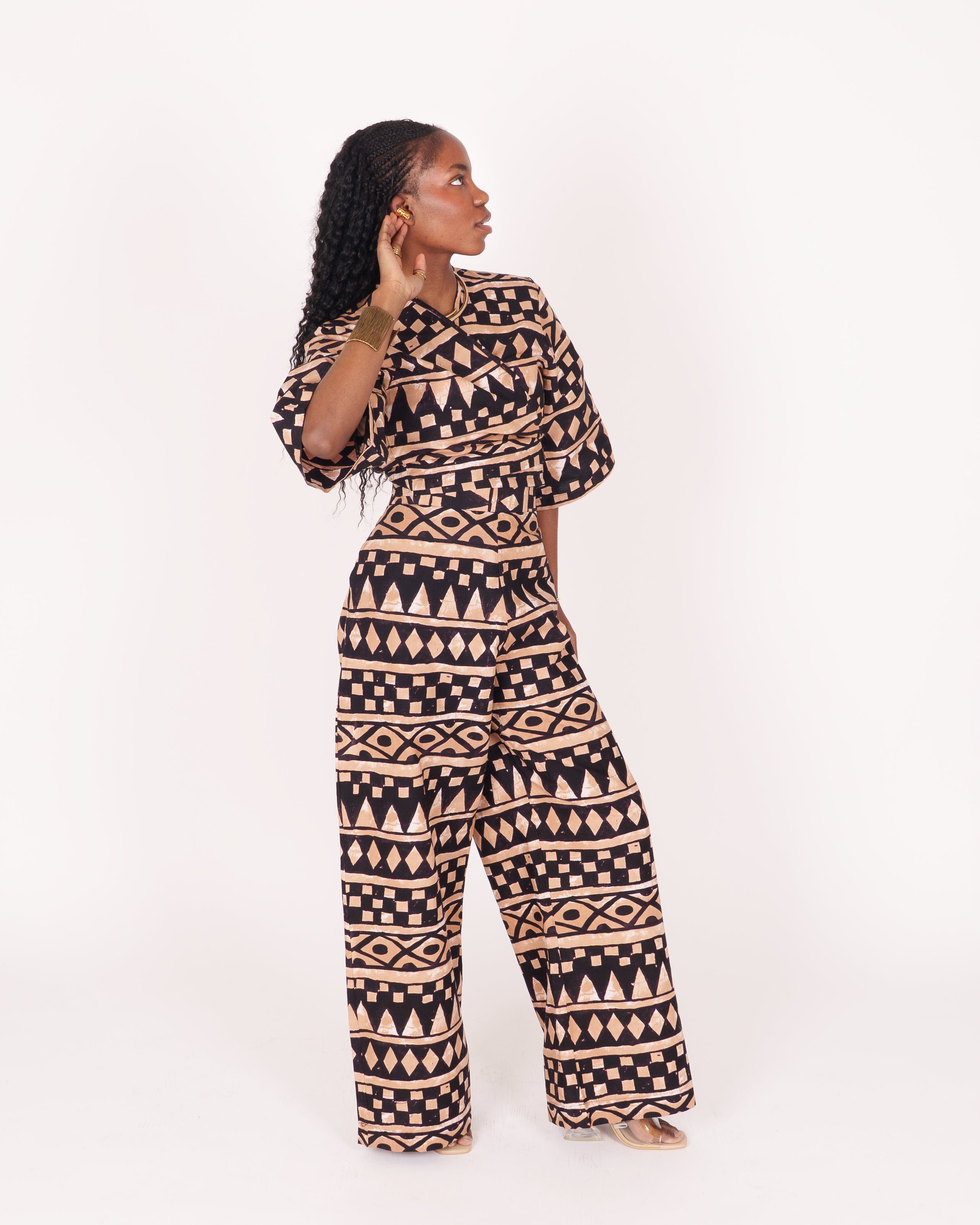 A relaxed fit suit featuring wide sleeves, a banded waist, and ankle-length wide leg pants, adorned with subtle geometric motifs.