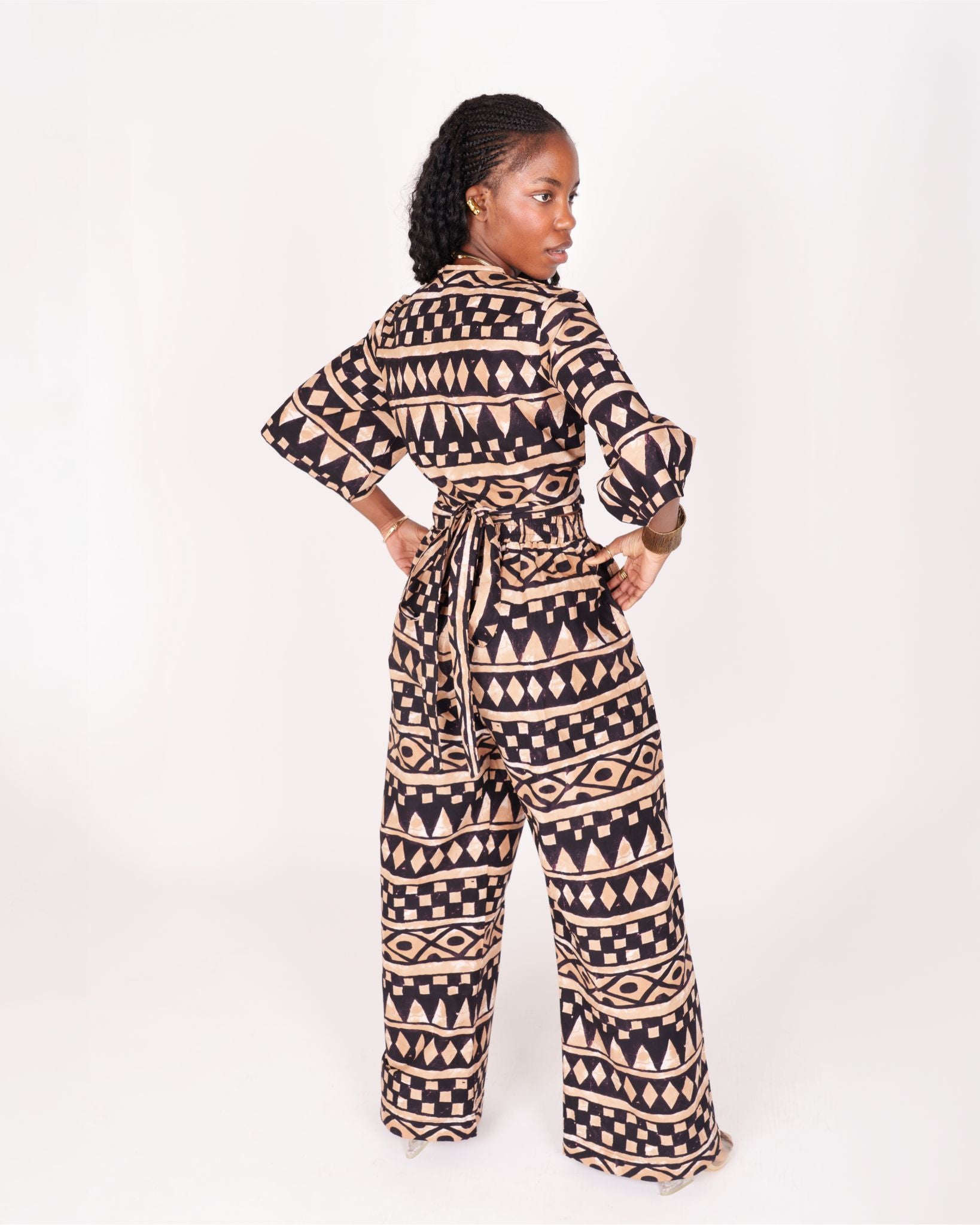 A relaxed fit suit featuring wide sleeves, a banded waist, and ankle-length wide leg pants, adorned with subtle geometric motifs.